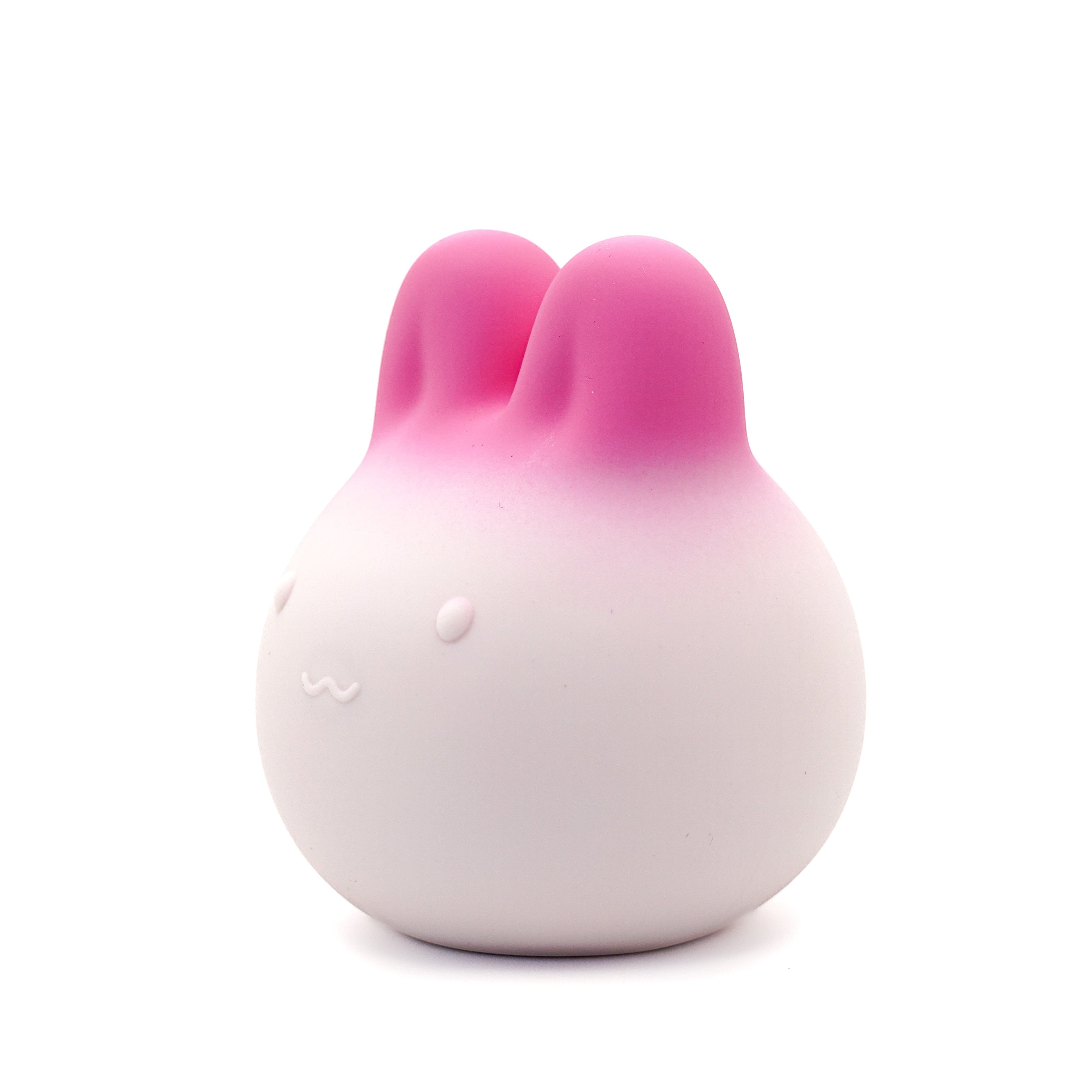 Get Closa pink gradient bunny-shaped silicone vibrator with a soft squeezable body and cute minimalist facial features.